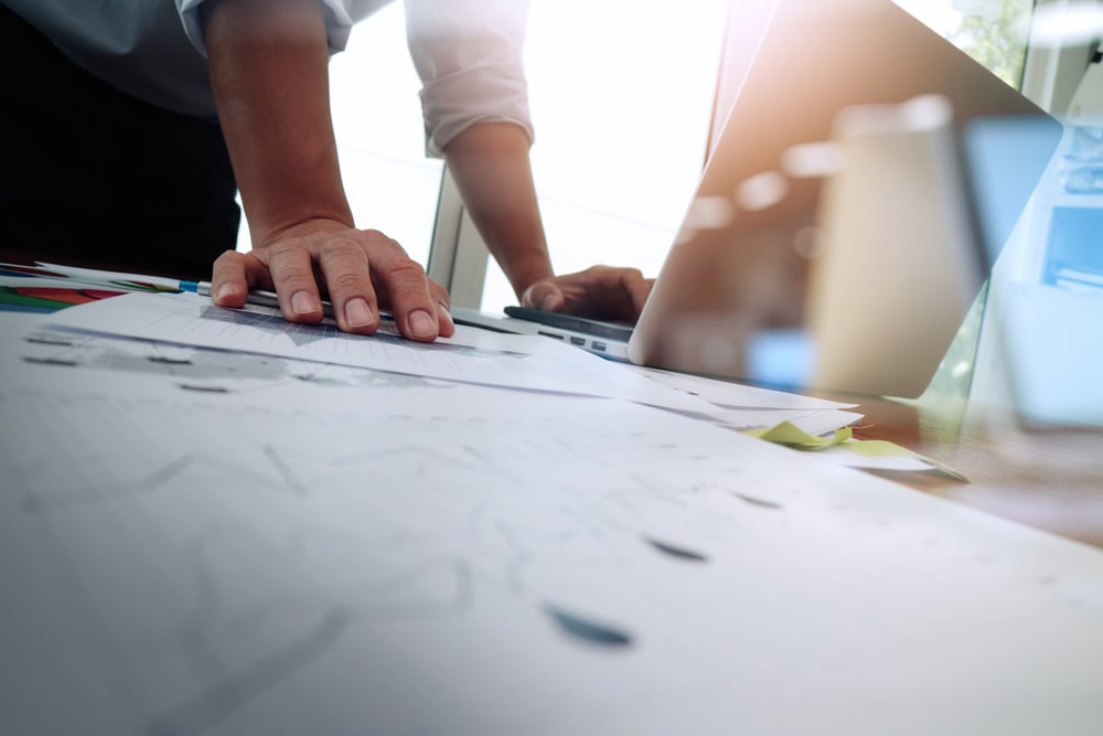 Double exposure of businessman hand working with new modern computer and business strategy as concept Double exposure of businessman hand working with new modern computer and business strategy as concept